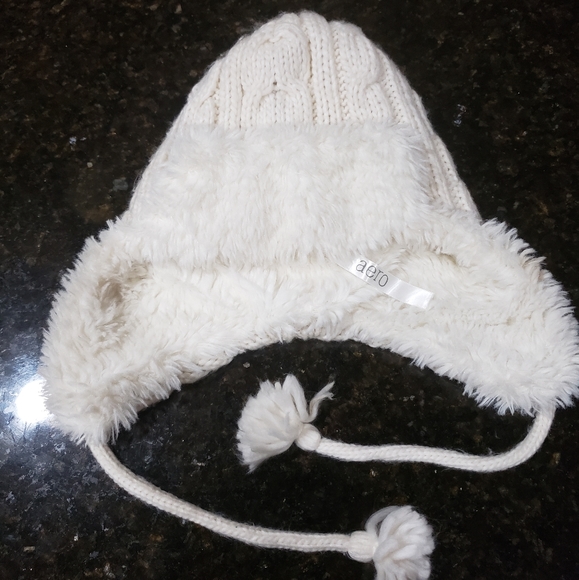 white knit hat with ear flaps